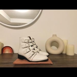NWOT Black Suede Studio white buckle booties